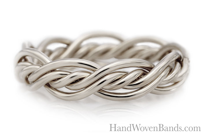 A silver five-strand ring with an intricate, twisted design isolated on a white background, with the text "handwovenbands.com" visible.