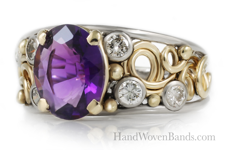 purple-gemstones-amethyst-artist-ring This is a custom swirl ring that has an amethyst mounted in it. You can have many engagement rings with different gemstones. This swirl ring has diamonds and gemstones in 14k yellow gold. It is an artisan ring.