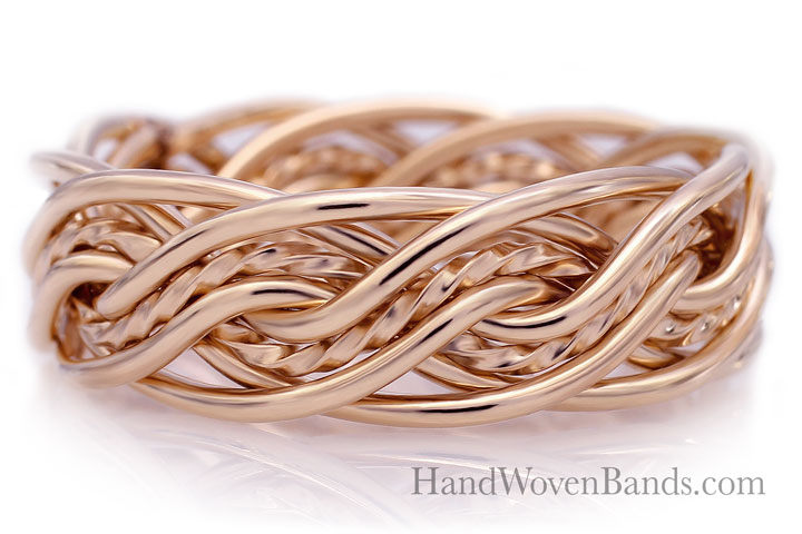 Gold eight-strand double weave wedding band with intricate braiding detail, displayed on a reflective white surface.