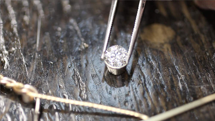 Custom work handmade by artist Todd Alan. This is him setting a diamond to show any customer can have their braided ring made custom with a custom work quote.