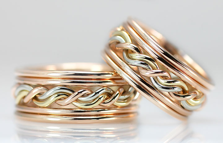 These are double outer bands, both in 14k rose gold with a tri-tone braided ring in the center. These braided wedding rings are made by hand by artist Todd Alan