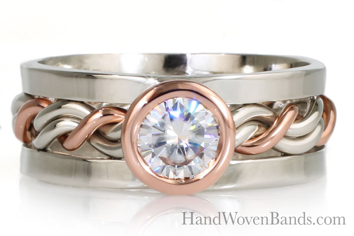 Very unique ring. Braided by hand with 14k rose gold and 14k white gold. This ring is set with a .5ct diamond in a bezel set rose gold setting. This ring also features our larger square outer bands