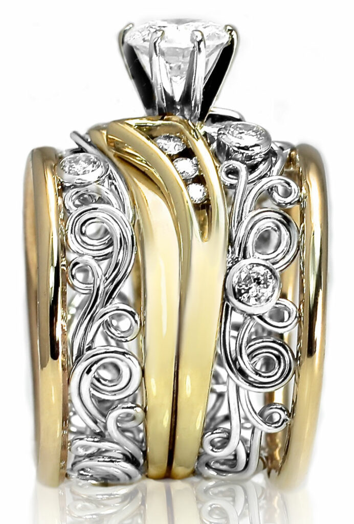 This unique artisan ring was handmade by Todd Alan. It is set with diamonds and uses swirl ring patterns and Filigree work. Its truly a masterwork ring.