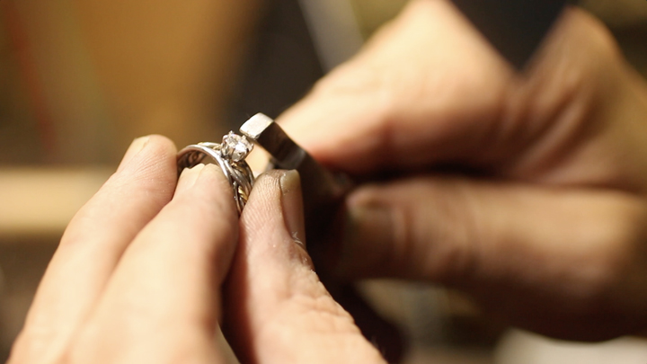 A close up of Todd Alan making his rings by hand. He is setting a diamond in one of his braided wedding rings. An example of our handmade braided rings.