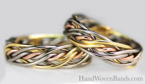 This is Todd Alan's seven strand twist weave braid. It is a braided wedding ring set made by hand by artist Todd Alan. This set of rings is a tri-tone or three color ring set