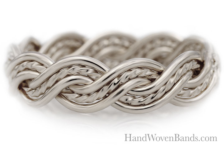 Close-up of a silver, handwoven ring with intricate six strand closed weave design, isolated on a white background with the text "handwovenbands.com".