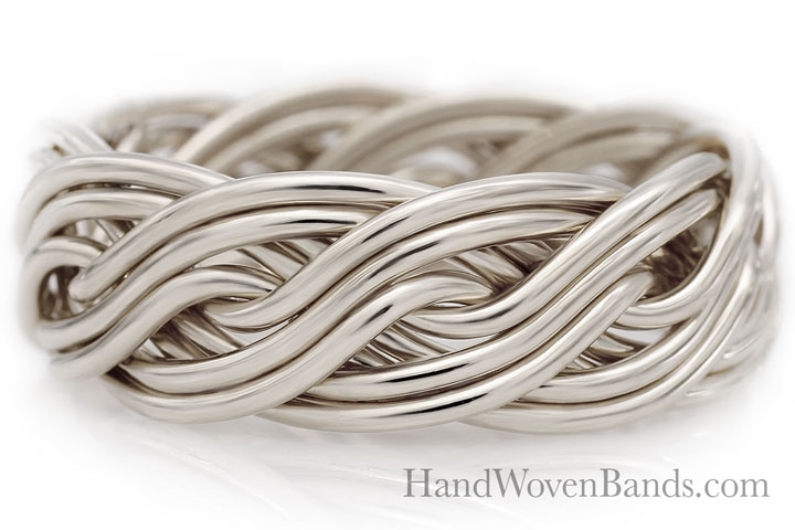 A close-up of a handwoven ten-strand silver metal ring with a smooth, intertwined design, isolated on a white background.