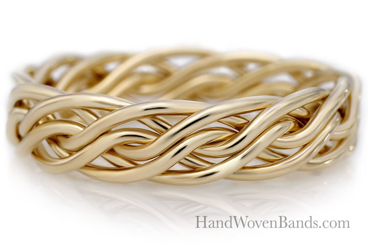 Rose gold braided wedding band with a glossy finish, set against a white background.