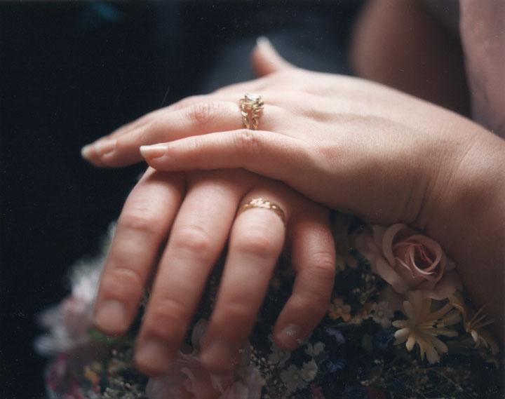 engagement rings on hand couple