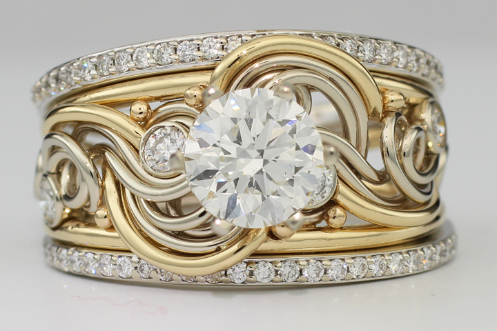 Gold and silver filigree masterpiece ring featuring a central large diamond surrounded by smaller diamonds.