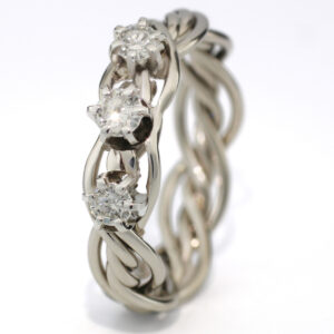 A silver braided ring featuring three prominent diamonds set in claw settings, isolated on a white background.