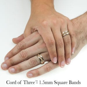 Gold and silver hand-braided wedding rings on hands, highlighting unique artisan design by Todd Alan.