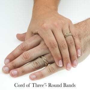 Gold braided wedding rings with unique handwoven design on two hands. Cord of Three™ rings by Todd Alan.
