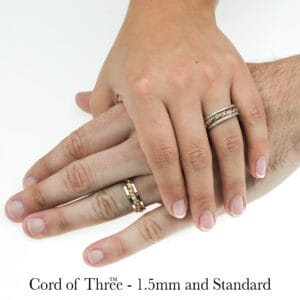 Handwoven gold and silver braided Cord of Three rings on two hands, showcasing unique craftsmanship by Todd Alan.