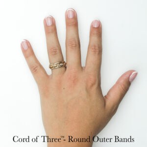 Hand-woven gold braided wedding ring with round outer bands on finger; unique craft by Todd Alan.