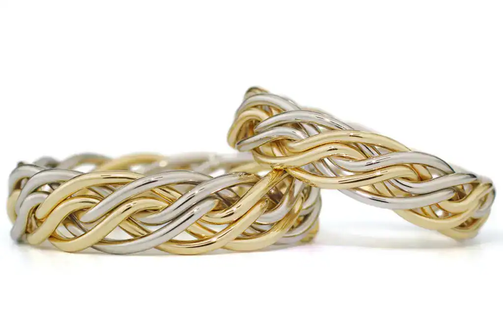 Handwoven braided wedding rings in yellow and white gold, unique artisan design by Todd Alan.